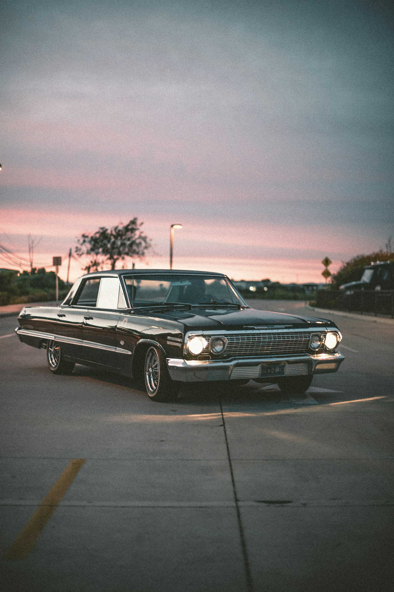 A classic muscle car photographed at sunset