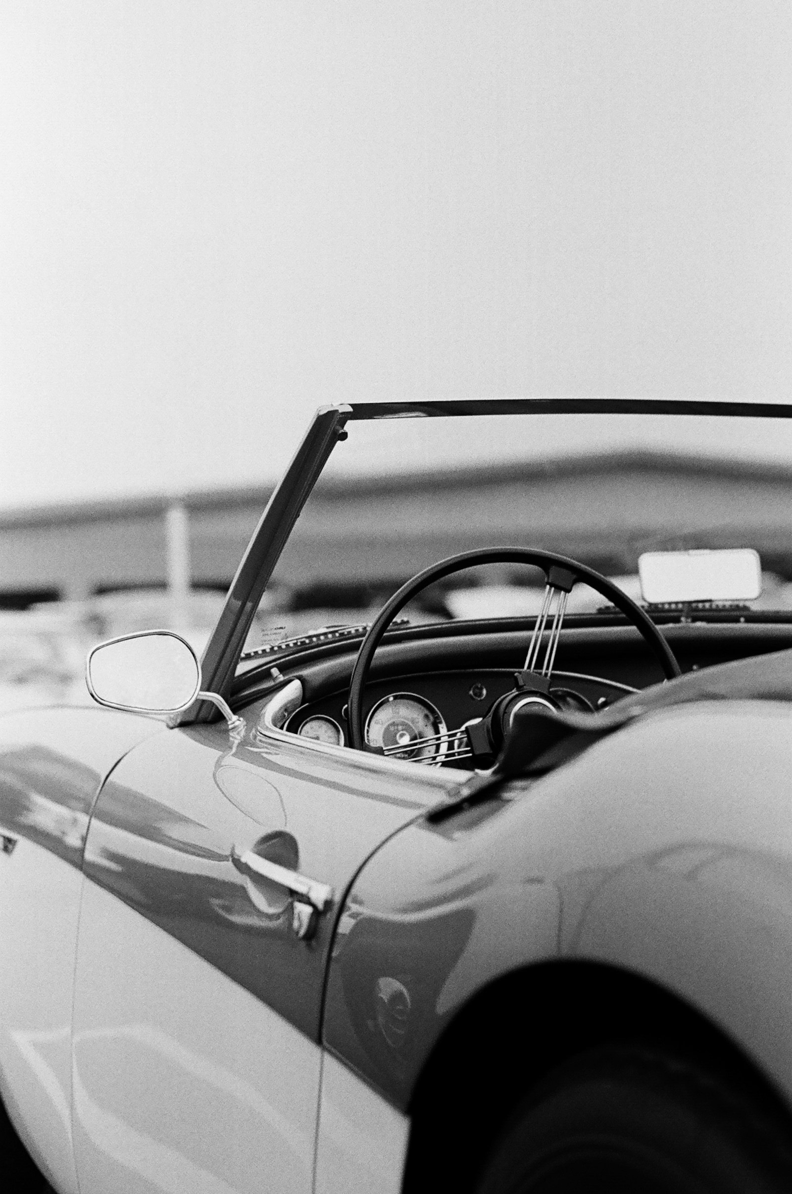 A classic car photographed in monochrome in a workshop