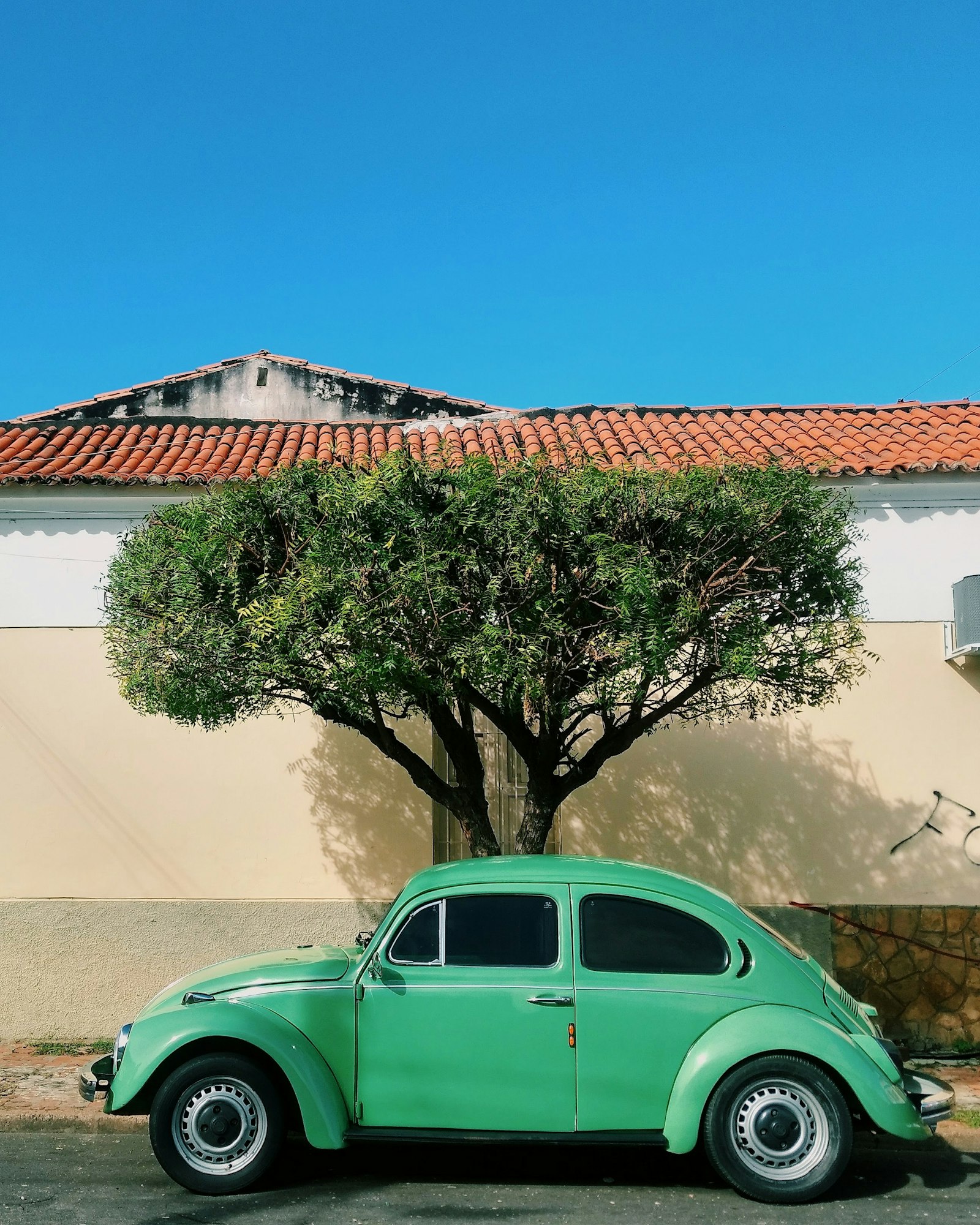 A teal Volkswagen Beetle